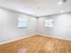 Light and airy bedroom with wood-look flooring and two windows at 8613 Beth Ct, Odessa, FL 33556
