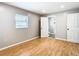 Well-lit bedroom with wood flooring and access to a full bathroom at 8613 Beth Ct, Odessa, FL 33556
