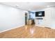 Large bedroom with wood flooring, a mounted TV, and access to the bathroom at 8613 Beth Ct, Odessa, FL 33556