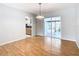 Bright dining room with hardwood floors and sliding glass doors leading to the patio at 8613 Beth Ct, Odessa, FL 33556