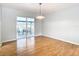 Bright dining room with hardwood floors and sliding glass doors leading to the patio at 8613 Beth Ct, Odessa, FL 33556