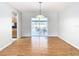 Bright dining room with hardwood floors and sliding glass doors leading to the patio at 8613 Beth Ct, Odessa, FL 33556