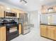 Modern kitchen with light wood cabinets, granite counters, and stainless steel appliances at 8613 Beth Ct, Odessa, FL 33556