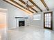 Living room features exposed beams and tile flooring at 8613 Beth Ct, Odessa, FL 33556