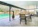 Covered patio furniture near the pool and a fire pit at 8613 Beth Ct, Odessa, FL 33556