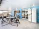 Covered patio adjacent to the pool, with outdoor seating and a refrigerator at 8613 Beth Ct, Odessa, FL 33556