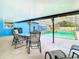Relaxing pool area with covered patio and outdoor seating at 8613 Beth Ct, Odessa, FL 33556