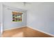 Well-lit bedroom featuring a large window and hardwood floor at 4317 S Trask St, Tampa, FL 33611