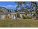 Tan house with a spacious lawn and mature trees at 4317 S Trask St, Tampa, FL 33611