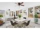Bright sunroom featuring neutral decor, multiple windows, and two ceiling fans at 4317 S Trask St, Tampa, FL 33611