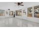 Bright sunroom featuring neutral decor, multiple windows, and two ceiling fans at 4317 S Trask St, Tampa, FL 33611