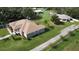 Aerial view of a house with a large yard and outbuildings at 2638 E Knights Griffin Rd Rd, Plant City, FL 33565