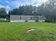 Tan mobile home with large grassy yard at 2638 E Knights Griffin Rd Rd, Plant City, FL 33565