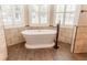 Soaking tub with tile surround and wood look tile floors at 2638 E Knights Griffin Rd Rd, Plant City, FL 33565