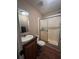 Bathroom featuring a single sink vanity, toilet, and enclosed shower at 2638 E Knights Griffin Rd Rd, Plant City, FL 33565
