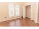 Bedroom featuring arched windows, hardwood floors and closet at 2638 E Knights Griffin Rd Rd, Plant City, FL 33565