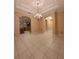 Spacious dining room featuring tiled floors, neutral walls, and elegant archways into the kitchen and foyer at 2638 E Knights Griffin Rd Rd, Plant City, FL 33565