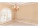 Bright dining room with a large window, chandelier, and tile flooring perfect for entertaining at 2638 E Knights Griffin Rd Rd, Plant City, FL 33565