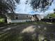 Home exterior featuring mature trees, well-maintained yard and ample parking at 2638 E Knights Griffin Rd Rd, Plant City, FL 33565