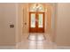 Elegant foyer showcasing tile flooring, a decorative light fixture, and beautiful double front doors at 2638 E Knights Griffin Rd Rd, Plant City, FL 33565