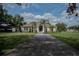 Attractive home with a well-kept lawn, mature trees, and an inviting entrance with a beautiful front door at 2638 E Knights Griffin Rd Rd, Plant City, FL 33565