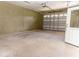 Spacious garage featuring a metal garage door, concrete floor and plenty of room for storage at 2638 E Knights Griffin Rd Rd, Plant City, FL 33565