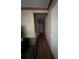 Hallway featuring wood floors and access to various rooms at 2638 E Knights Griffin Rd Rd, Plant City, FL 33565