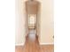 Hallway view with hardwood flooring leading to the main bathroom and soaking tub at 2638 E Knights Griffin Rd Rd, Plant City, FL 33565