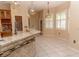 Bright eat-in kitchen featuring modern countertops, wood cabinetry, and pendant lighting at 2638 E Knights Griffin Rd Rd, Plant City, FL 33565