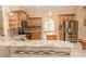 Well-equipped kitchen featuring granite countertops, stainless steel appliances, and custom cabinetry at 2638 E Knights Griffin Rd Rd, Plant City, FL 33565