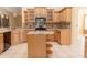 Well-equipped kitchen featuring tile floors, granite countertops, and wooden cabinetry at 2638 E Knights Griffin Rd Rd, Plant City, FL 33565