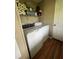 Bright laundry room with modern washer and dryer, and convenient shelving for storage at 2638 E Knights Griffin Rd Rd, Plant City, FL 33565
