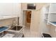 Laundry room and storage with sink, washer, dryer, and access to kitchen at 2638 E Knights Griffin Rd Rd, Plant City, FL 33565