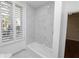 Clean bathroom with white tub and marble tile at 405 Central Ave # 210, St Petersburg, FL 33701