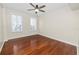 Well-lit bedroom with hardwood floors and ceiling fan at 405 Central Ave # 210, St Petersburg, FL 33701
