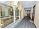 Hallway with hardwood floors, columns, and a view of the interior courtyard at 405 Central Ave # 210, St Petersburg, FL 33701