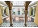 View of a building's interior courtyard with glass ceiling, ornate columns, and tile floors at 405 Central Ave # 210, St Petersburg, FL 33701