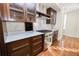 Modern kitchen with dark wood cabinets, marble countertops, and stainless steel appliances at 405 Central Ave # 210, St Petersburg, FL 33701