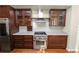 Modern kitchen with dark wood cabinets, marble countertops, and stainless steel appliances at 405 Central Ave # 210, St Petersburg, FL 33701