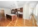 Open concept kitchen with island, stainless steel appliances, and hardwood floors at 405 Central Ave # 210, St Petersburg, FL 33701