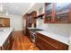 Modern kitchen with dark wood cabinets, marble countertops, and stainless steel appliances at 405 Central Ave # 210, St Petersburg, FL 33701