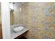 Small powder room with marble vanity and unique wallpaper at 405 Central Ave # 210, St Petersburg, FL 33701