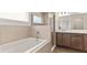 Elegant bathroom featuring a soaking tub with shower, vanity, and window with natural light at 6929 161St E Ter, Parrish, FL 34219