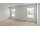 Bright bedroom with two windows and neutral carpeting, offering a serene atmosphere at 6929 161St E Ter, Parrish, FL 34219