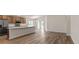 Bright, open kitchen with stainless steel appliances, a spacious island, and wood grain flooring at 6929 161St E Ter, Parrish, FL 34219