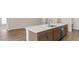 Spacious kitchen island with seating, a sink, and ample storage space underneath at 6929 161St E Ter, Parrish, FL 34219