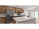 Stylish kitchen featuring stainless steel appliances, a large island, and ample cabinet space at 6929 161St E Ter, Parrish, FL 34219