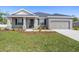 Charming single-story home featuring a well-manicured lawn and attached two-car garage at 2634 58Th E Cir, Palmetto, FL 34221