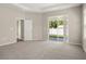 Spacious main bedroom featuring carpet floors, a walk-in closet, and sliding glass doors to the backyard at 2634 58Th E Cir, Palmetto, FL 34221