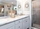 Elegant bathroom boasts double sinks, marble countertop, and a glass shower at 2650 58Th E Cir, Palmetto, FL 34221